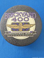Top view of round tin with Brickyard 400 inaugural race graphics