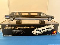 Boxed black 1996 Lincoln Limousine die-cast model on display stands