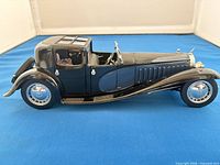 Left side profile of the model car showing body, wheels and finish