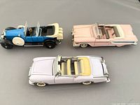 Top view of three diecast convertibles showing colours and interiors