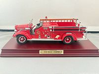 Front and side view of 1948 Mack Pumper on display base