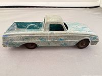 Left side profile of diecast Ford Ranchero showing paint wear and overall condition