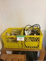 Two yellow crates filled with assorted extension cords