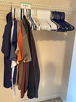 Cluster of shirts on hangers in closet