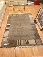 Full view of rug showing overall pattern, colors and fringe
