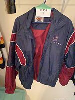 Front view of Vancouver Canucks Starter jacket showing Orca logo and zip front