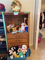 Overall view showing Sony boombox, Cabbage Patch doll, plush toys, flashlight, toy hammer and wood clock