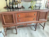 Full front view of mahogany sideboard with drawers and cabinet doors