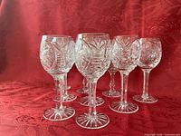 Group view of all nine matching crystal wine glasses showing pattern and height