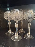 Front view of the four Czech crystal glasses on shelf