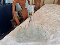 Liquor set on table showing decanter, six glasses, tray
