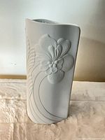 Front view showing floral relief design on vase