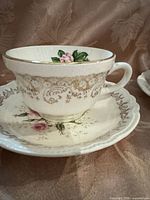 Close-up of one cup on saucer showing pattern and trim