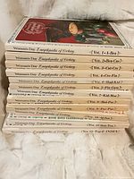 Stacked spines showing all 12 volumes with titles and alphabetical ranges