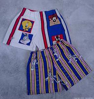 Front view of both pairs showing character graphics and stripe patterns
