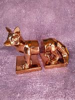 Full view of both gold cubist fox bookends side by side