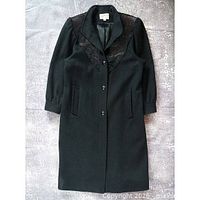 Full view of black Jules For Progress coat showing length, buttons, pockets, lace detail