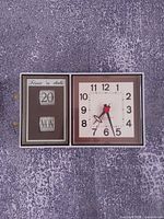 Front view showing day-date window and time dial