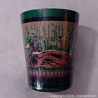 Full view of cylindrical trash can showing duck motif and color palette
