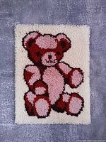 Full view of teddy bear latch hook rug on flat surface