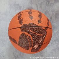 Full view of basketball showing Shaq hand print graphic and facsimile signature