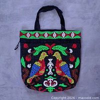 Front view of fully beaded handbag showing bird and floral design
