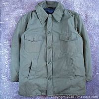 Full front view of green field jacket showing pockets, buttons, collar