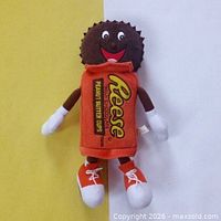 Full view of Reese’s plush doll showing head, torso, limbs, and shoes