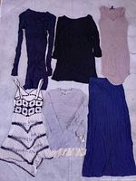 All six dresses laid out on floor