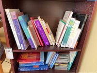 Full bookshelf view showing quantity and variety of books and stack of spa music CDs