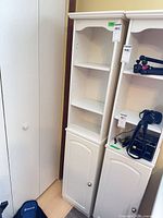Full view of white MDF cabinet with tag 484 beside similar unit