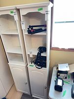 Two matching white MDF cabinets, lot item is the right unit