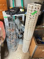 two main fence rolls metal and plastic standing upright