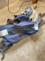 Bag, folded hammock fabric, portions of metal stand