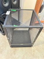 Overall view of black metal and mesh reptile cage front and top