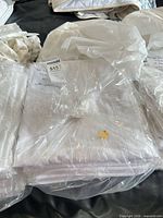 Stacks of white sheets bundled in plastic