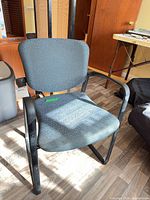 Front view of office chair showing frame, upholstery and general condition