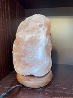 Front view of Himalayan salt lamp on wooden base
