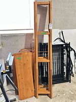 Disassembled pine shelving parts including side frames and shelf boards