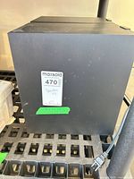 Side view of one speaker showing MaxSold tag and power cord from unrelated item