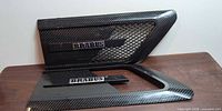 Front view of both carbon fiber side vent trims with Brabus badges