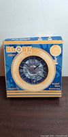 Front of boxed Elegance Wheel Art Clock showing tire design clock face
