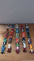 25 Hot Wheels die-cast cars arranged in four columns