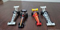 Top view of four NHRA Hot Wheels dragsters