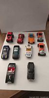 All ten die-cast cars arranged on white background, front and top views visible