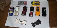 All ten die-cast cars laid out on white paper
