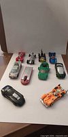 All ten die-cast cars laid out on white backdrop