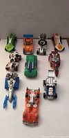 All ten Hot Wheels cars grouped on white background