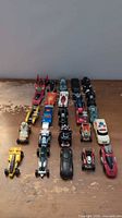 Full group of 25 die-cast vehicles arranged in rows