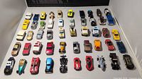 Overhead view of 40 die-cast vehicles arranged in five rows